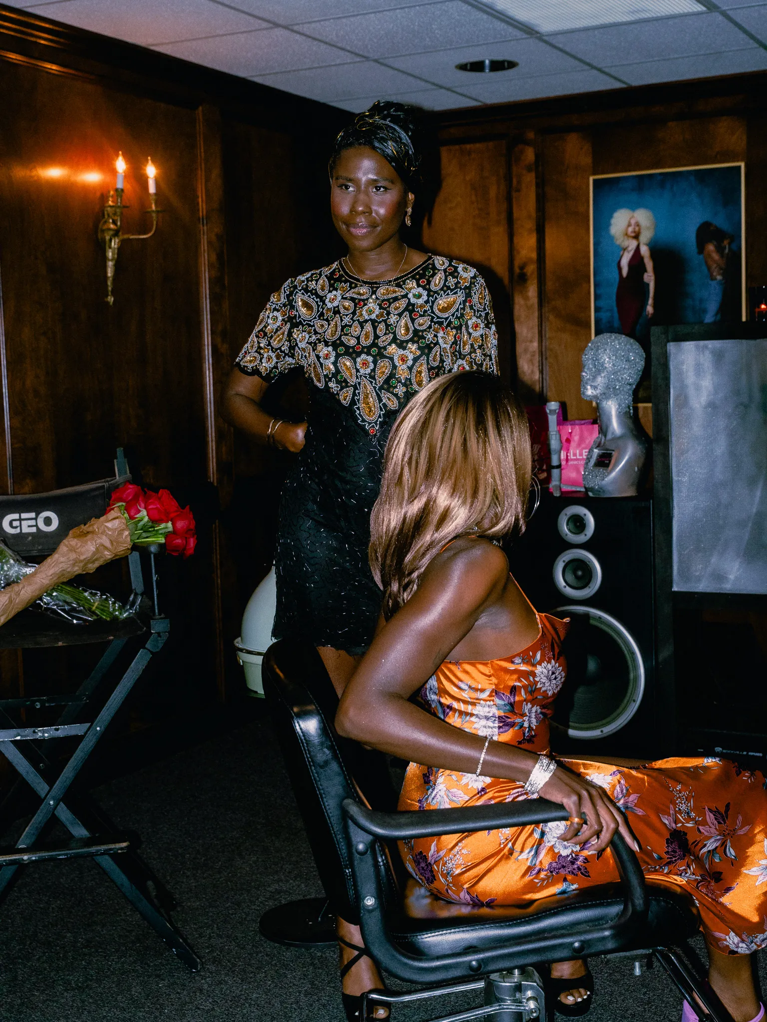 Nala backstage in a beaded top with a bouquet of roses nearby