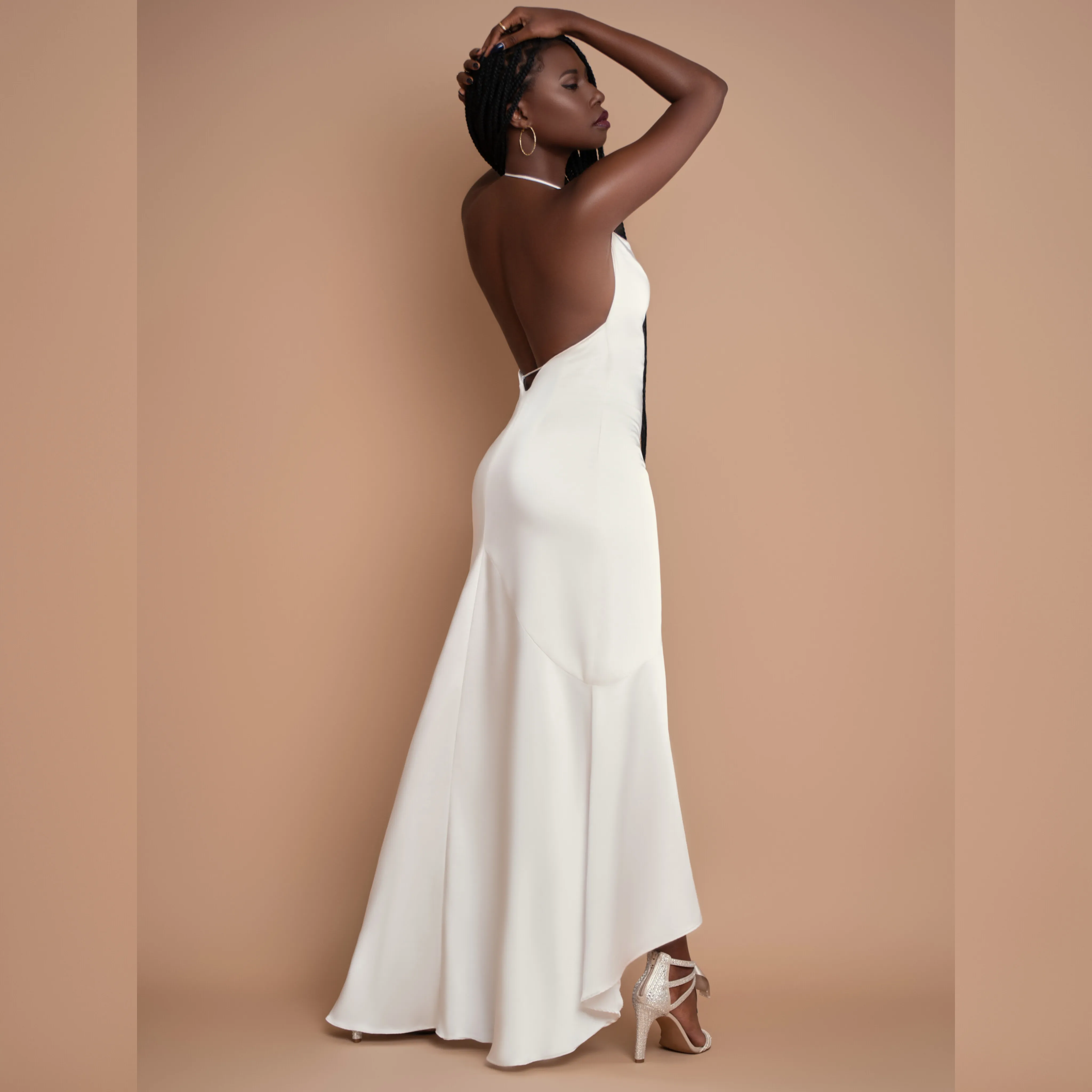 Nala in a backless white gown, studio portrait