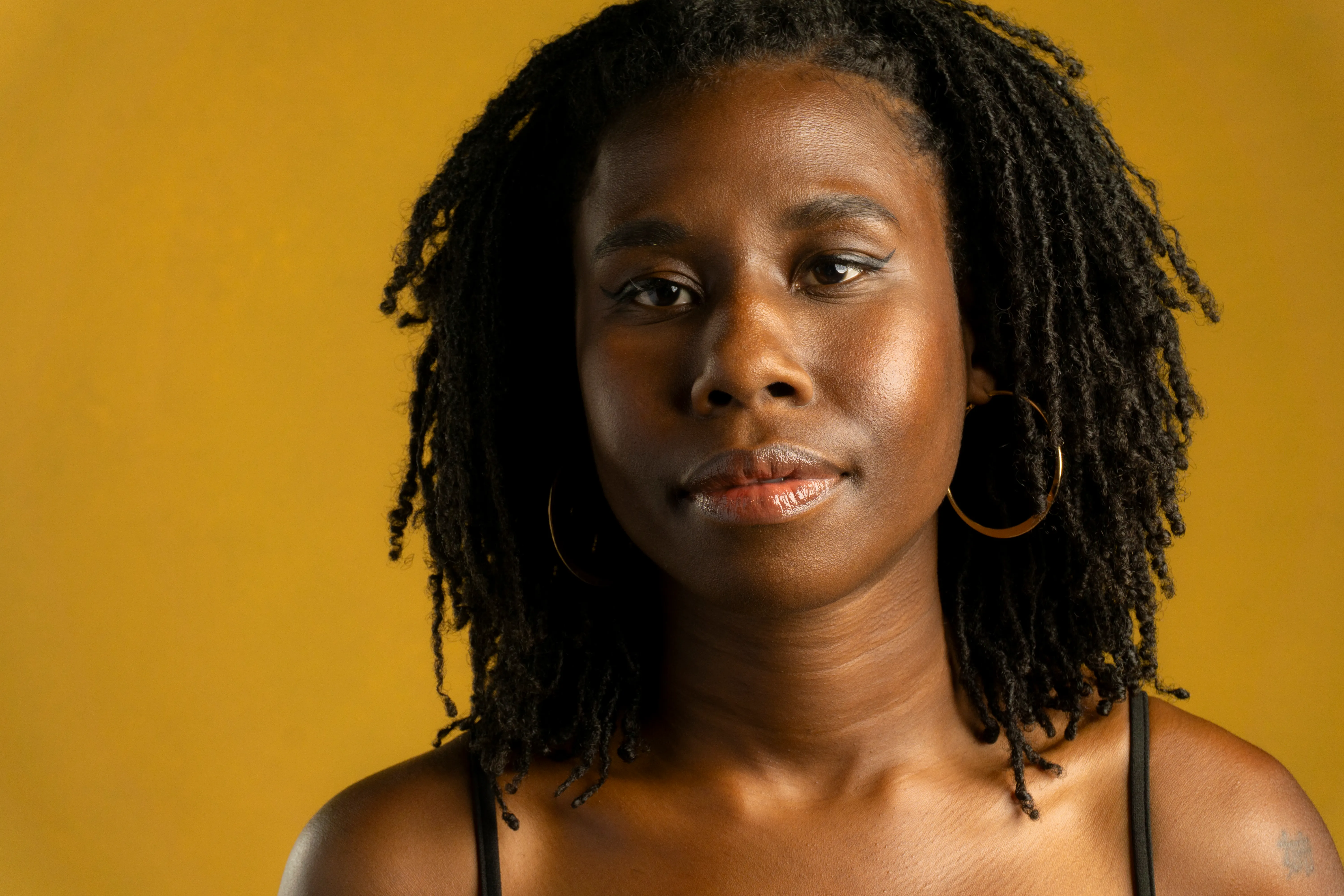 Nala close-up portrait against a yellow studio backdrop